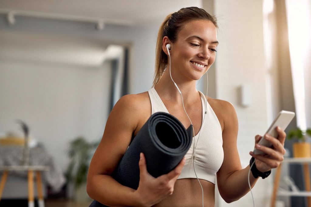 woman-looking-at-her-phone-during-workout